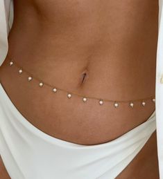 Gold Pearl Body Belt Chain Small/Medium 25" -30" (adjustable) Medium/Large 30"-35" (adjustable) 18K Gold Plated Stainless Steel PLEASE USE A MEASURING TAPE TO MEASURE YOUR WAIST BEFORE PURCHASING. THEY DO NOT RUN THE SAME AS PANT SIZES. White Adjustable Body Chain, White Body Jewelry With Adjustable Chain, White Adjustable Body Jewelry, White Adjustable Body Jewelry With Chain, Body Belt, Gold Body Chain, Belt Chain, Chain Anklet, Chain Gold