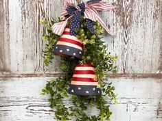 a patriotic wreath hanging on the side of a door