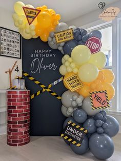 a birthday decoration with balloons and caution signs