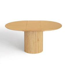 a round wooden table sitting on top of a white floor