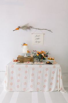 a white table topped with cakes and flowers