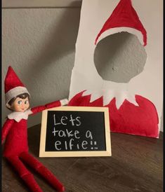 an elf with a sign that says let's take a elfie