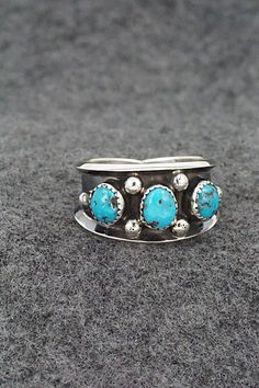 This turquoise and sterling silver ring was made by Navajo silversmith Paul Largo. The inside is stamped sterling.Size: 10Length: 1/2"Free shipping on all orders! We ship with USPS and always include tracking. All orders ship within a day of payment.Returns are accepted up to 30 days after you receive your order. Just send us a message. Our shop offers cash back or store credit. The item must be returned in new condition. Sterling Silver Turquoise Concho Ring, Sterling Silver Turquoise Ring With Concho, Sterling Silver Turquoise Rings With Concho Detail, Southwestern Turquoise Open Ring In Sterling Silver, Southwestern Sterling Silver Turquoise Open Ring, Southwestern Style Turquoise Open Ring In Sterling Silver, Western Style Untreated Sterling Silver Rings, Southwestern Untreated Turquoise Sterling Silver Ring, Untreated Southwestern Turquoise Sterling Silver Ring