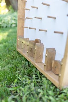 a wooden board game sitting in the grass