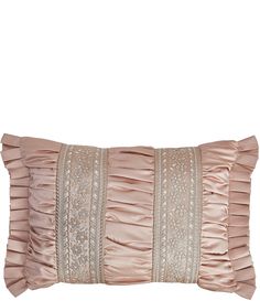 a pink pillow with ruffled edges and beading