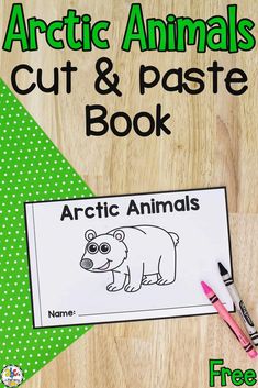 an arctic animal cut and paste book with two markers on the table next to it