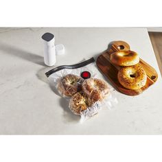 donuts and other pastries are sitting on a counter top next to a blender