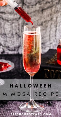 halloween mimosa recipe in a wine glass with blood pouring out of the top