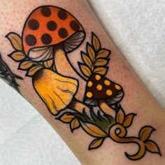 a tattoo with a mushroom and leaves on it