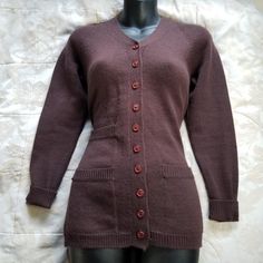 "Vintage 70s 100% wool dark brown knit cardigan sweater. Features 3/4 length sleeves, button up front, v-neck, and three pockets. Tagged a junior size large.  Women's size xs-small recommend. Measurements taken while garment laid flat and are approximate Bust: 16\" Waist: 14.5\" Length 26\" Modeled on a women's size Small  Excellent vintage condition, please note there is a light scent of lanolin, it's an light earthy scent that is common on articles that are 100% wool. I have sensitive skin, and the article is minimally scratchy. #wool #cardigan #dark #academia #sweater cottage cottagecore core gorpcore fairycore grunge fairy woodsy mori earthy" Fitted Wool Vintage Cardigan, Vintage Brown Cardigan With Pockets, Brown Vintage Long Sleeve Cardigan, Brown Button-up Cotton Cardigan, Vintage Brown Wool Cardigan, Womens Cardigan, Cardigan Tops, Knit Sweater Cardigan, Sweater Blouse