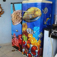 two refrigerators decorated with fish and sea creatures