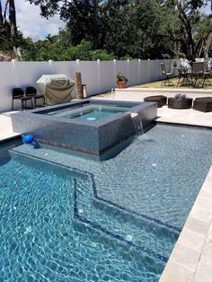 a pool with a hot tub in the middle