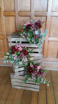 three wooden crates with flowers in them