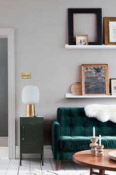 a living room filled with furniture and pictures on the wall