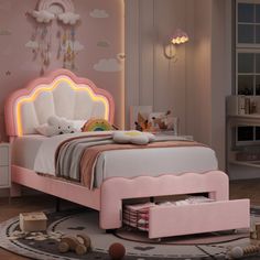 a child's bedroom with pink furniture and accessories