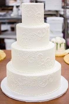 a white wedding cake sitting on top of a table