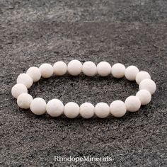 This is a white coral bracelet made of 8 mm beads. Our beads of white coral are so amazing! Incredible pure white. This gorgeous is an irreplaceable spring-summer accessory. CORAL represents diplomacy and concurrence.  It quiets the emotions and brings peace to within the self.  Facilitates intuition, imagination, and visualization.  Coral expedites and accelerates the transfer of knowledge. Coral strengthens the circulatory system and the bones of the body.  It stimulates tissue regeneration an White Spiritual Pearl Bracelet With Gemstone Beads, Spiritual White Pearl Bracelet With Gemstone Beads, White Pearl Bracelet With Gemstone Beads For Spiritual Wear, White Crystal Bracelet With Round Beads For Meditation, Spiritual White Pearl Bracelet With 8mm Beads, Spiritual Style White Pearl Bracelet With 8mm Beads, White Hypoallergenic Round Beaded Bracelets, White Round Beads Pearl Bracelet Spiritual Style, White Crystal Bracelet With 8mm Beads