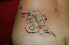 a woman's stomach with a flower tattoo on it