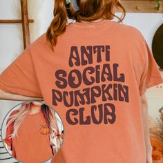 Embrace your pumpkin passion with our Comfort Colors AntiSocial Pumpkin Club Shirt. This charming tee boasts a delightful front corner pumpkin graphic and proudly features "antisocial pumpkin club" text on the back. Ideal for introverts who adore pumpkins and crave solitude, this shirt is a perfect blend of Halloween spirit and comfort. Whether it's for a Jack O' Lantern costume or everyday wear, its oversized fit and cozy feel make it a must-have addition to your collection. Pumpkin & spice up Lantern Costume, Jack O Lantern Costume, Fall Tshirts, Pumpkin Graphic, Patch Shirt, Patches Shirt, Fall Tee, Autumn Gifts, Pumpkin Shirt