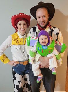 a man and woman dressed up as toy story characters with a baby in their arms