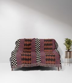 a black and white checkered blanket sitting on top of a couch