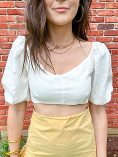 Look stunning in the Elsa Tie Back Bubble Sleeve Top. This cute and stylish crop top pairs perfectly with high-waisted skirts for a complete vacation look. It features eye-catching puff sleeves and tie-back details that add a unique and fashionable touch. Elastic backing with tie closure Elastic sleeve cuffs Puff sleeves 70% cotton 30% linen Lined 100% cotton Stylist Review: •Model is 5’5” with a 32” bust and wearing a size Small. Fits True To Size. Waisted Skirts, Bubble Sleeve Top, Stylish Crop Top, Vacation Looks, Bubble Sleeve, Tie Backs, Tie Back, Puff Sleeves, Puff Sleeve