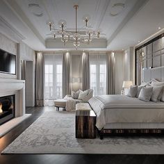 a bedroom with a large bed and fireplace in it