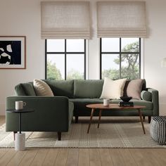 a living room with two couches and a coffee table in front of large windows