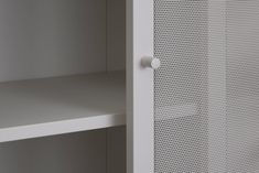 a white cupboard with some shelves in it