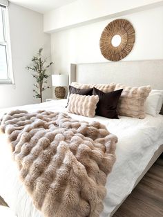 a bedroom with a large bed covered in furry blankets