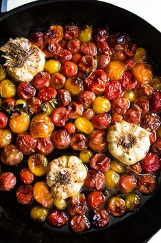 tomatoes and other fruits are cooking in a skillet