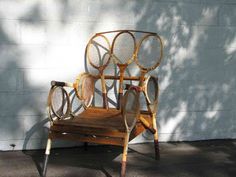 an old chair made out of tennis rackets