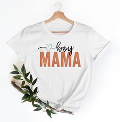 "Boy Mama T-Shirt Hi! Welcome to my store, I'm delighted to see you here. My store's main goal is to provide you with premium everyday apparel with the best graphic t-shirts.  DESCRIPTION * Printed and shipped from the USA. * We use state of art printing on soft and quality shirts. * Different size options; crewneck, youth, women's v-neck, toddler, and baby size options.  * Effective customer service and expedited shipping.  * Solid colors are 100% airlume combed and ringspun cotton.  * Heather colors 52/48 cotton/polyester. * Shoulder taping. Side-seamed. Fitted at bicep. Tear-away label. 4.2 oz. SIZES AND COLORS * Please refer to the size charts for measurements before placing an order. * You can compare our numbers to one of your favorite shirts to make sure. * Unisex shirts are true to White Slogan Shirt For Gift, White Slogan Shirt As A Gift, Slogan Short Sleeve Shirt For Gift, White Top With Funny Text For Mother's Day, White Tops With Funny Text For Mother's Day, White Letter Print Shirt As A Gift, White Slogan Top As Gift, White Letter Print Shirt As Gift, White Text Print Top For Gift