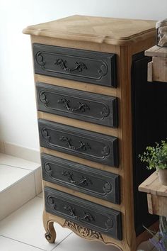 an old dresser with five drawers and a potted plant