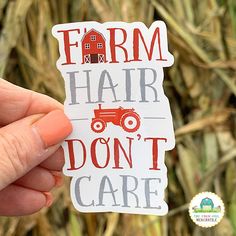 someone holding up a sticker that says farm hair don't care