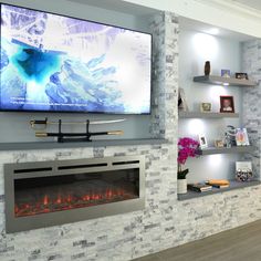 a television mounted on the wall above a fireplace