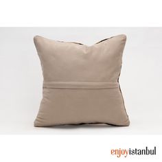 a beige pillow with a zipper on it