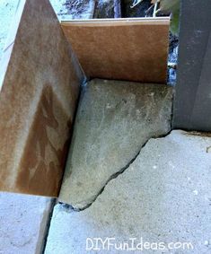 the corner of a concrete block with cracks in it's center and bottom part