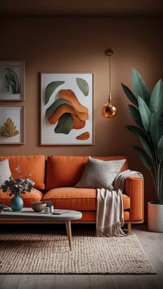 a living room with an orange couch, coffee table and potted plant in the corner