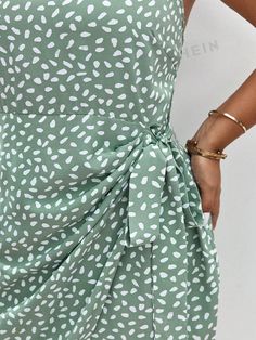 This Chic Frenchy Plus Allover Print Halter Dress with Knot Side Wrap is expertly crafted with a flattering halter neckline and a knot side wrap detail. Made with a stylish allover print, this dress is the perfect addition to your wardrobe for a chic and fashionable look. Feel confident and stylish in this timeless piece. Color : Mint Green Style : Casual Details : Knot, Wrap Type : Fitted Pattern Type : All Over Print Sleeve Length : Sleeveless Neckline : Halter Waist Line : High Waist Hem Shaped : Wrap Length : Knee Length Fit Type : Regular Fit Fabric : Non-Stretch Material : Woven Fabric Composition : 100% Polyester Care Instructions : Machine wash or professional dry clean Sheer : No Size US Bust Hip Size Length Waist Size 0XL 12 43.3 48 37 37.4 1XL 14 45.7 50.4 37.8 39.8 2XL 16 48 52 Sleeveless Summer Wrap Dress With Tie Back, Summer Fitted Wrap Dress With Tie Back, Fitted Summer Wrap Dress With Tie Fastening, Green Tie Waist Wrap Dress For Vacation, Summer Fitted Wrap Dress With Tie Fastening, Fitted Tie Back Wrap Dress For Summer, Summer Wrap Mini Dress With Tie Waist, Casual Green Wrap Dress, Fitted Printed Wrap Dress For Summer