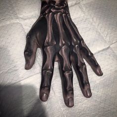 a person's hand with black paint on it