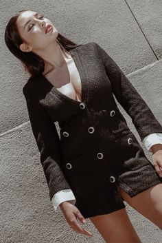 An ultra-chic design in a cozy, textured fabric — a match made in heaven! Crafted from a knit blend in midnight black, the Odette blazer dress features a deep V collarless neckline, button-down front, structured shoulders and a mini-dress length. Contrasting mock sleeves peek out from underneath for a polished, layered look, while the dress is finished with four patch pockets and gemstone accents. #blazerdress #blazer #blazeroutfitsforwomen #blackblazer Chic V-neck Cardigan For Office, Chic V-neck Cardigan For Formal Occasions, Chic V-neck Outerwear For Night Out, Winter V-neck Blazer With Buttons, Chic V-neck Party Blazer, V-neck Winter Evening Outerwear, Chic V-neck Winter Blazer, V-neck Blazer Dress With Buttons For Work, Chic V-neck Outerwear With Buttons