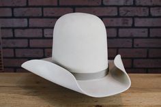 Inspired by the hat worn by Dan Blocker as “Hoss”. Open crown for a 10 gallon capacity. From 1959-1972 Dan Blocker portrayed Eric "Hoss" Cartwright for an incredible 415 episode run. In honor of Blocker's memorable performance Baron is offering a replica of Hoss' iconic 10-gallon hat. Please allow 8-12 weeks for completion of your order. Store credit or exchange only. Hoss Cartwright, Dan Blocker, Los Angeles Street, Color Bone, 12 Weeks, Hat Band, Hat Sizes, Cowboy Hats, Nashville