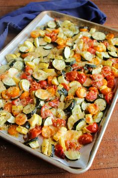 a pan filled with roasted zucchini and tomatoes