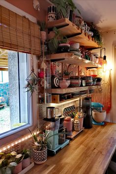 a kitchen counter with pots and pans on it, next to a large window