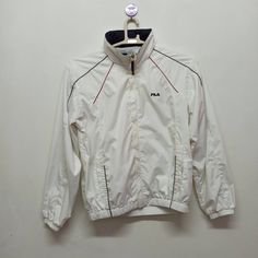 Brand : Fila  Condition : Used -  Very good  Colour : White  Size : 95 100% Polyester / Soft Fabric Lining  Actual Size Measurements  Pit to pit : 20  Inch Length : 25 Inch Sporty White Windbreaker For Sports Season, White Sports Windbreaker, White Track Jacket For Light Sports In Winter, White Track Jacket For Gym During Sports Season, White Moisture-wicking Windbreaker For Winter, Winter White Moisture-wicking Windbreaker, White Track Jacket For Sports Season, White Track Jacket For Outdoor Sports Season, Sporty Long Sleeve Windbreaker For Light Sports