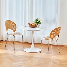 two chairs and a table in front of a window