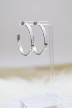 The White Luxury H Hoop Silver Earrings showcase a contemporary H-shaped hoop design, beautifully crafted from polished silver. They are elegantly accented with pristine white embellishments, enhancing their sophisticated and luxurious appeal. Size: 40 mm Closure: Butterfly Earring Backs Material: Brass with Silver Plating with Rhodium Coating Lead Free and Hypoallergenic Hoop Silver Earrings, Butterfly Earring, Hoop Design, Butterfly Earrings, Tennis Bracelet, Earring Backs, The White, Silver Earrings, Embellishments