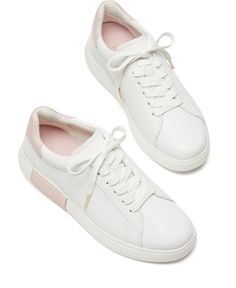 Kate Spade New York's Lift sneakers update trend-right white sneaker style with a pop of color in a contrast collar on a timeless low-top profile. Modern White Platform Sneakers With Contrasting Heel, Slip-on Low-top Sneakers With Gum Sole, White Platform Sneakers With Contrast Sole For Spring, White Slip-on Sneakers With Textured Sole, Slip-on Sneakers With Gum Sole And Round Toe, Modern White Slip-on Sneakers With Perforated Toe Box, Sporty Slip-on Sneakers With Contrasting Heel Counter, Sporty Slip-on Sneakers With Contrasting Heel, Slip-on Low-top Platform Sneakers With White Sole