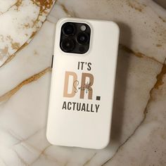 an iphone case with the words it's dr actually on it sitting on a marble surface